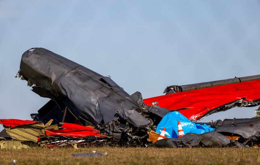 A damaged plane remains in the open field at the Dallas Executive Airport on Sunday, Nov....