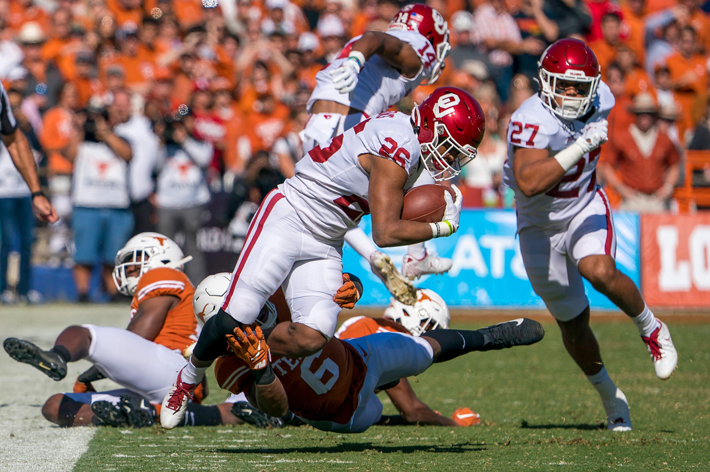 Oklahoma running back Kennedy Brooks (26) is brought down by Texas linebacker Juwan Mitchell...