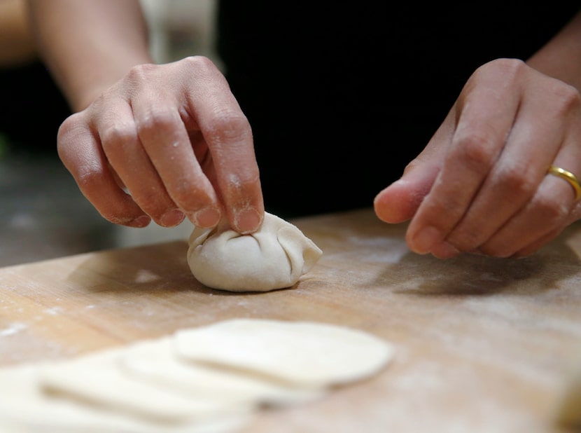 Nann Kham works on sealing a dumpling  
at Hello Dumpling in East Dallas.