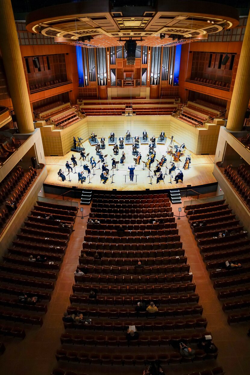 Music director Fabio Luisi conducts a socially-distanced orchestra before a...