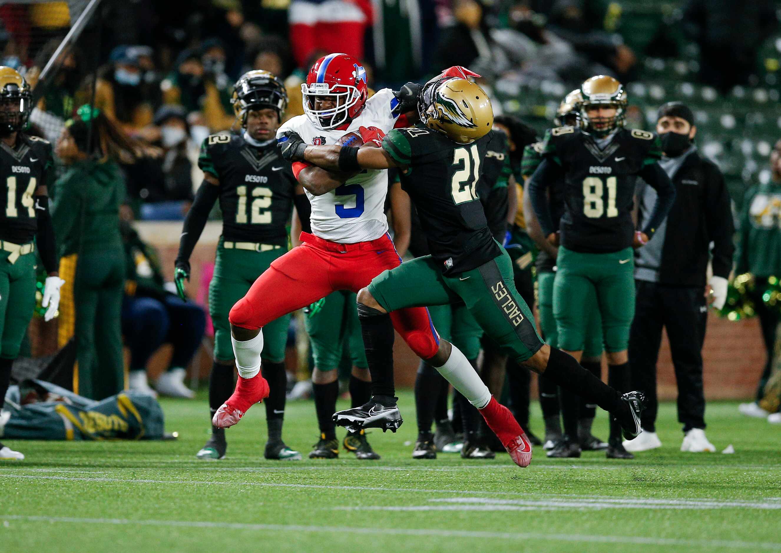 Duncanville junior running back Malachi Medlock (5) battles DeSoto sophomore safety Jaden...