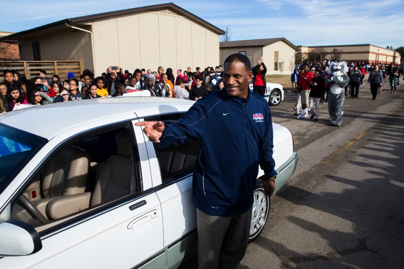 Teacher's aide Kevin MaBone was surprised with a car during a presentation by students and...