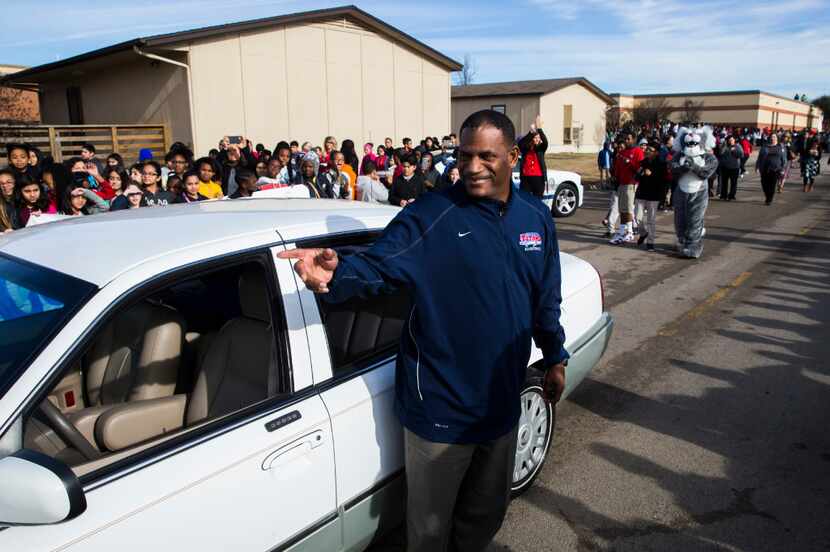 Teacher's aide Kevin MaBone was surprised with a car during a presentation by students and...