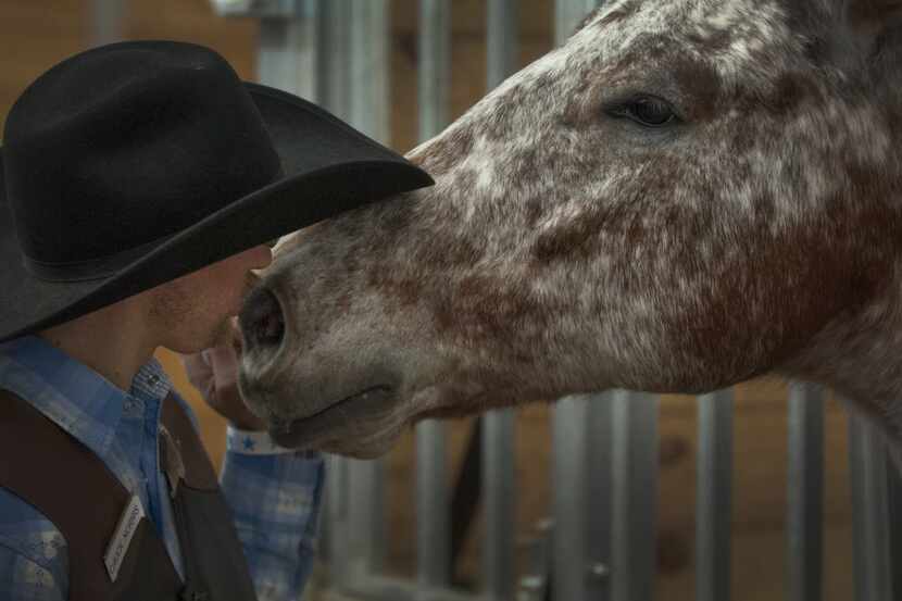 Ryan Wolf of Dallas gives Malibu a kiss at the Equest Ridefest 2015 Festival of Hope at the...