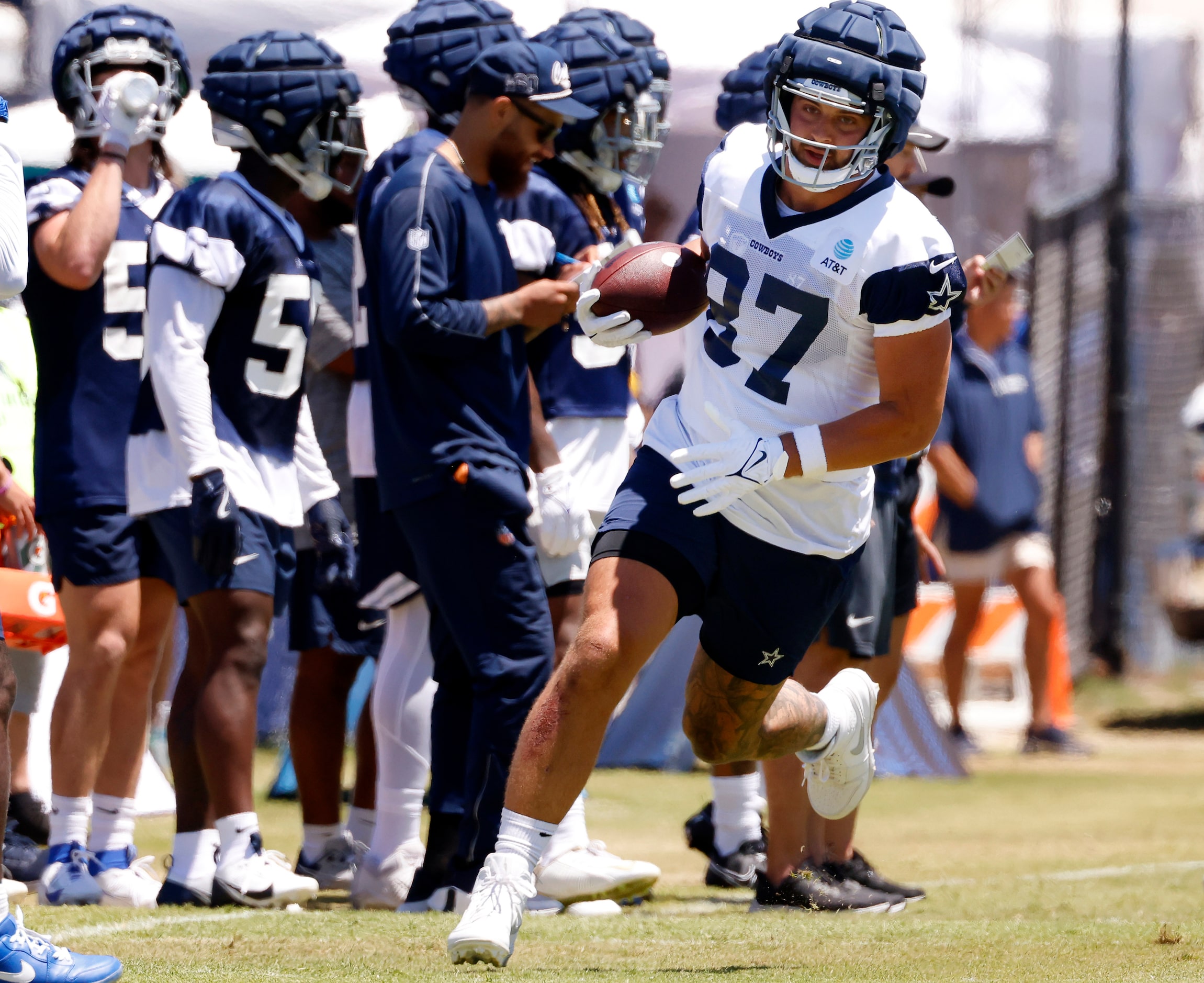 Dallas Cowboys tight end Jake Ferguson (87) carries the ball after completing a pass during...