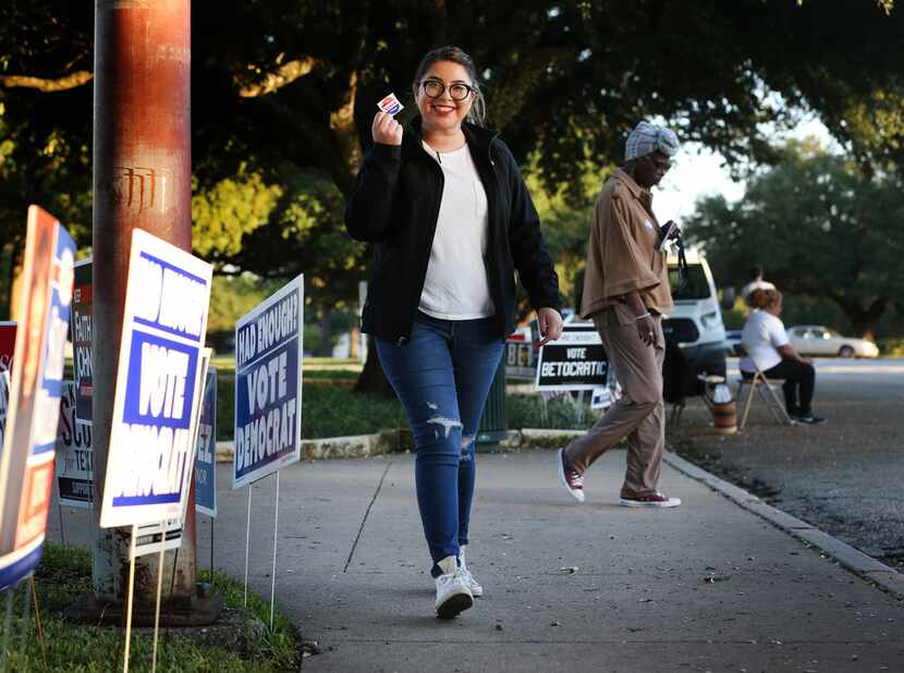 Maria Garcia, a first-time voter, leaves the polling station holding her "I Voted Today!"...