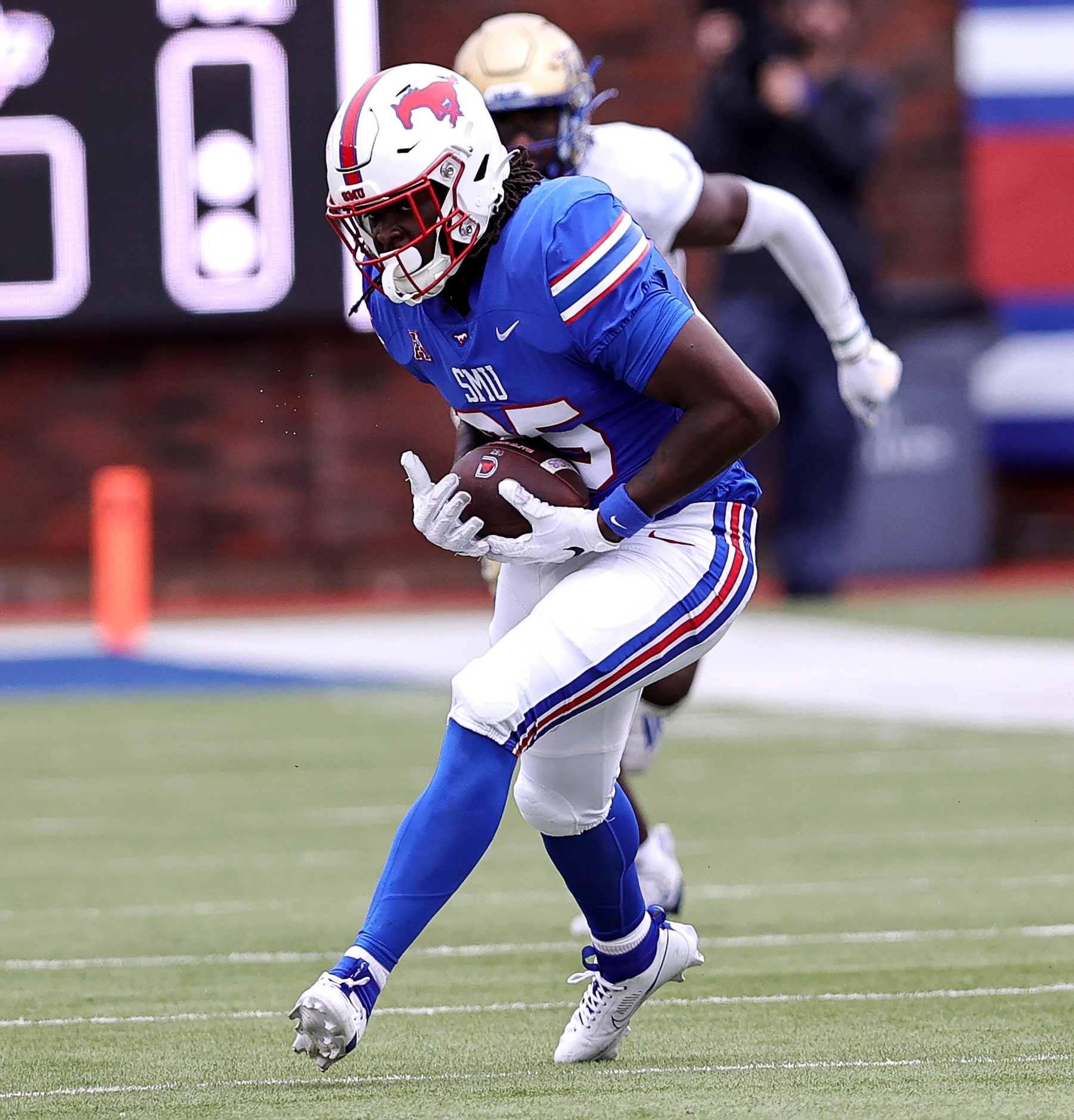 SMU tight end Adam Moore makes a reception then goes 52 yards against Tulsa during the first...