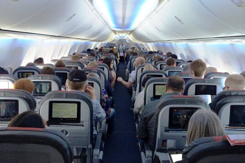 One of American Airlines' new 737s. The cabin gives standard economy passengers less space,...