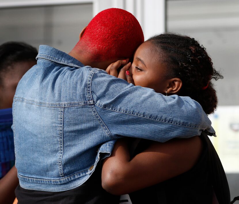 
Twanna Washington (left) comforts her daughter Terrianna Washington, 13, a sixth-grader, as...