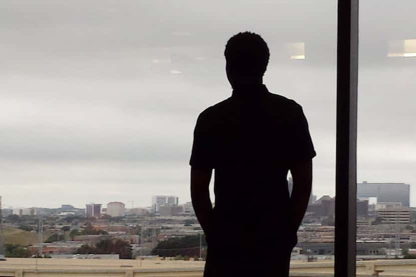 Thomas Johnson looks out at the Dallas skyline at a court appearance in August of 2014....