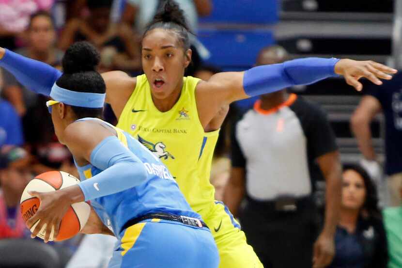Dallas Wings forward Kayla Thornton (6) looms large defensively as she guards Chicago Sky...
