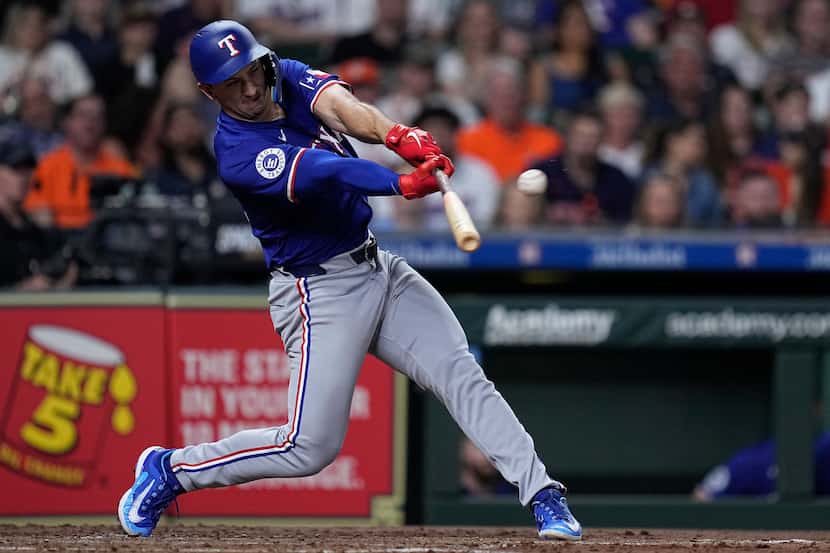 Texas Rangers designated hitter Wyatt Langford hits a two-run double against the Houston...