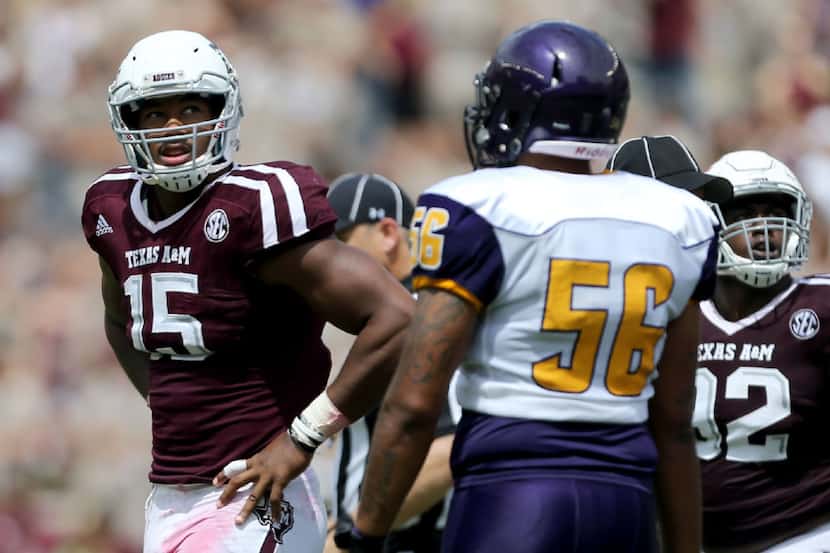 Texas A&M defensive lineman Myles Garrett (15) looks towards the score board for a replay...