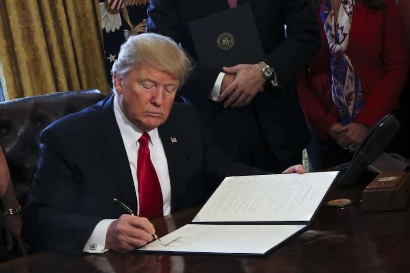 WASHINGTON, DC - FEBRUARY 3: (AFP OUT) U.S. President Donald Trump signs Executive Orders in...