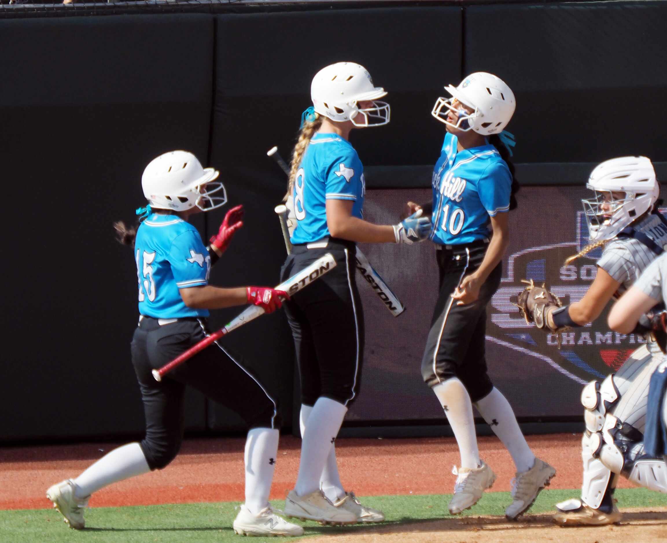 Prosper Rock Hill batters Gabrielle Luna (left) and Ella Berlage (center) and baserunner...