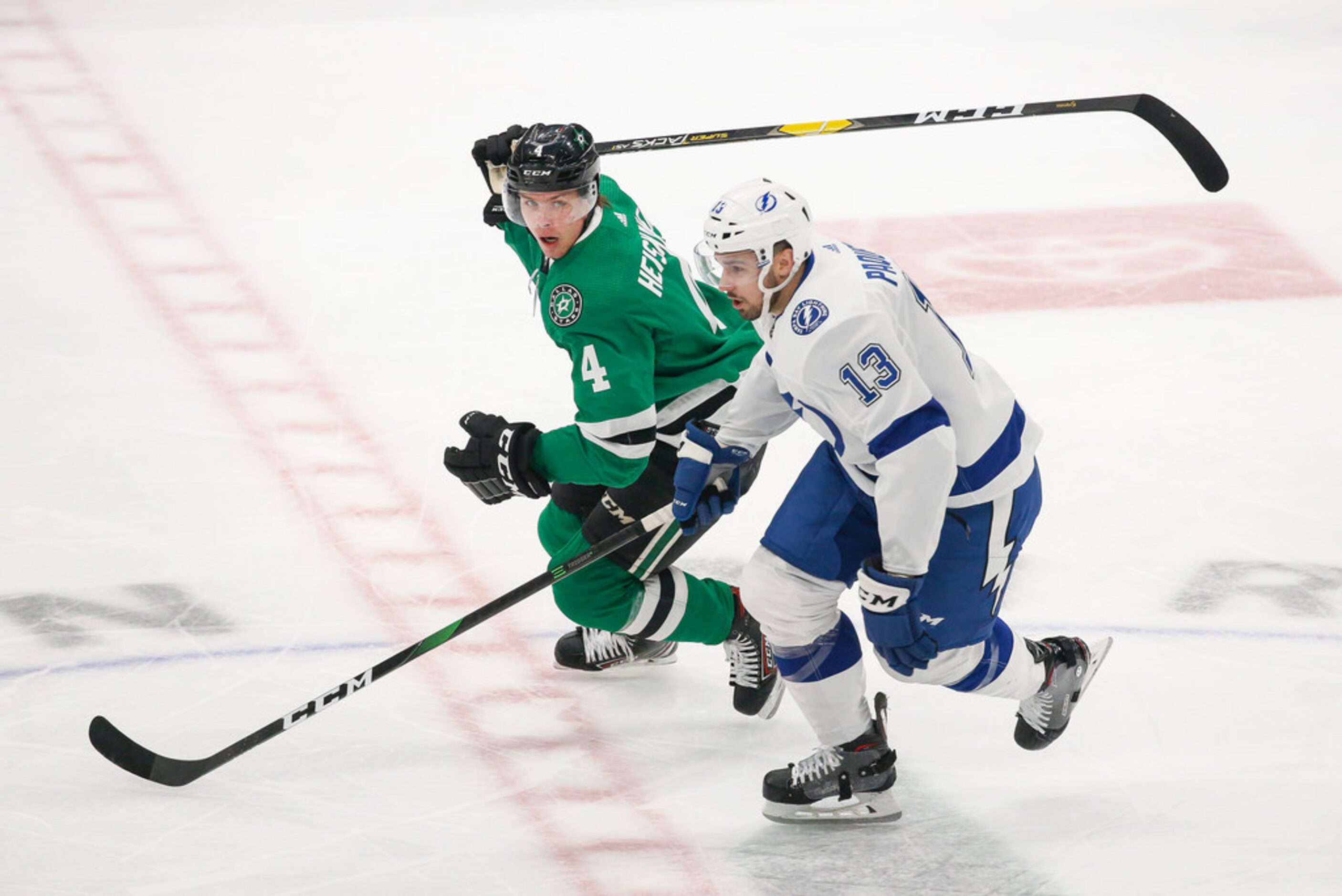 Dallas Stars defenseman Miro Heiskanen (4) and Tampa Bay Lightning center Cedric Paquette...