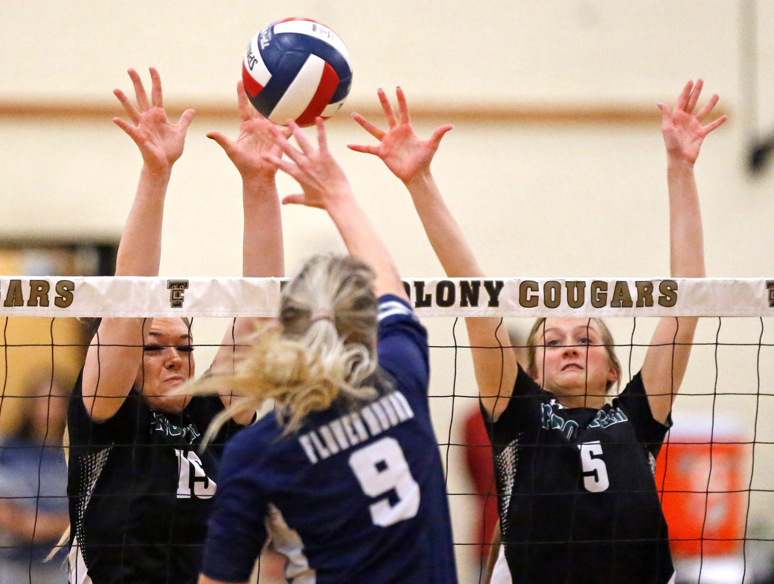 Flower Mound High School outside hitter Gabby Walker (9) tries to het a hit through Prosper...