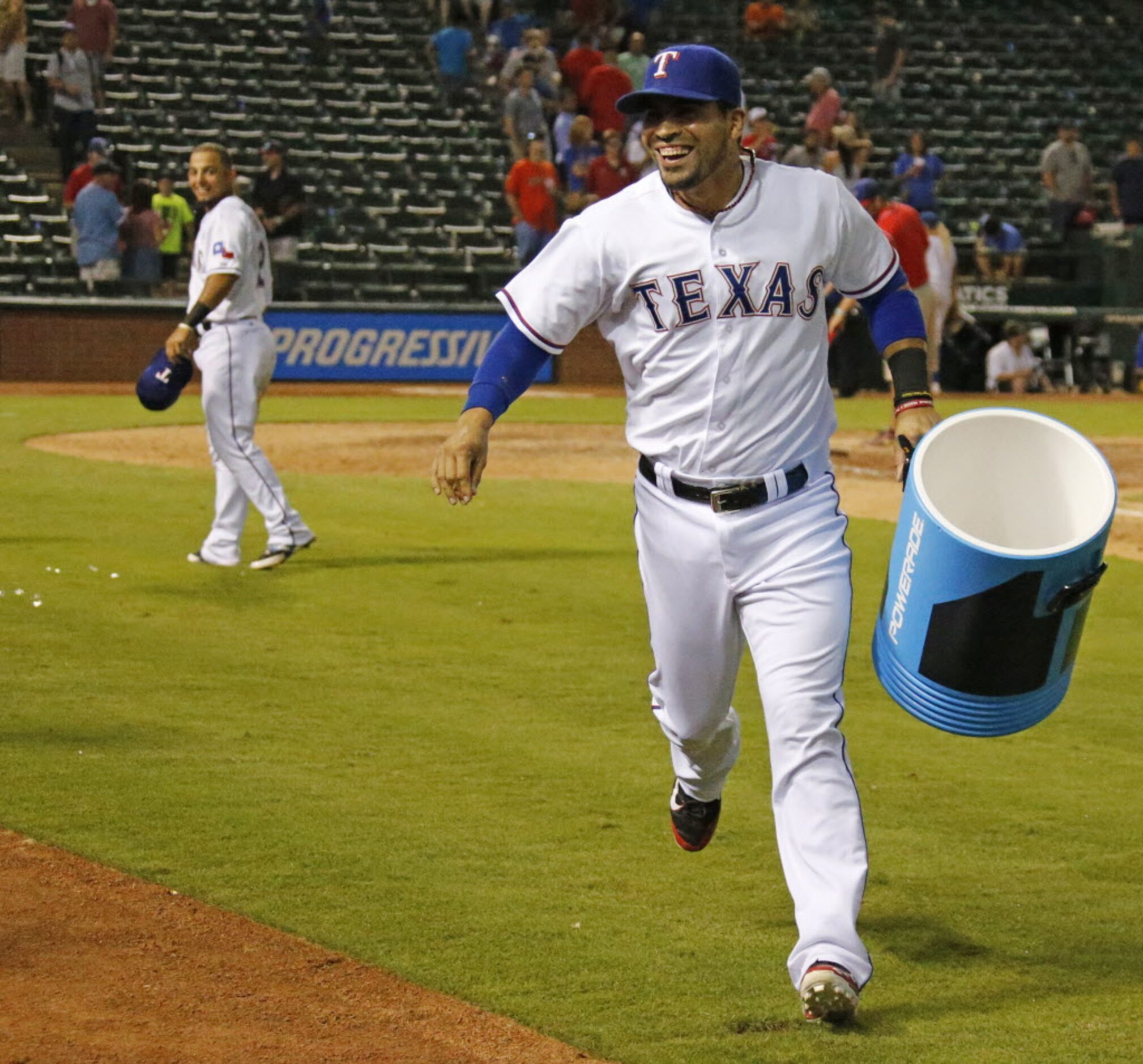 Texas catcher Robinson Chirinos runs from the scene of the crime after dousing teammate...