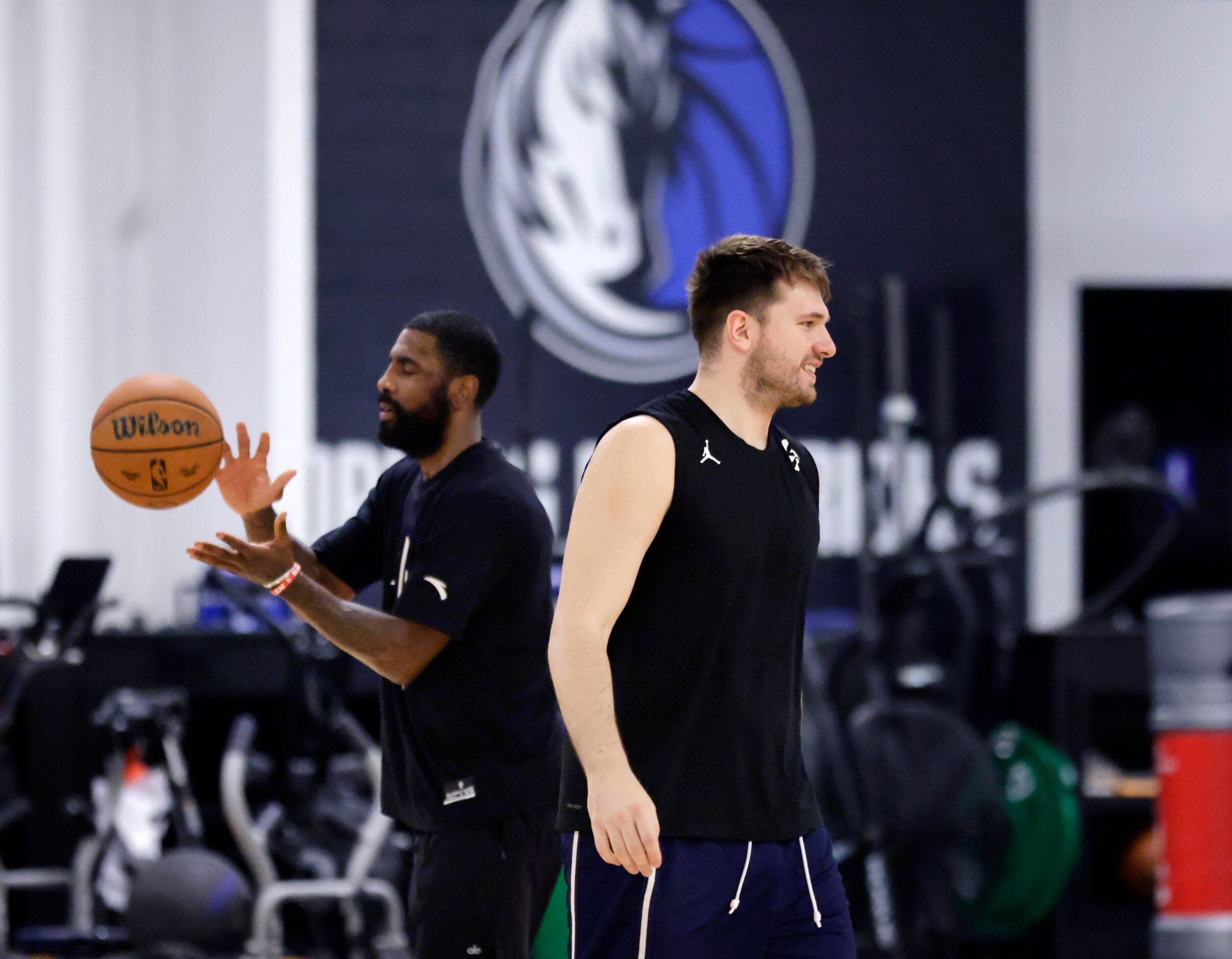 Dallas Mavericks guards Luka Doncic (right) and Kyrie Irving shoot 3-pointers during...