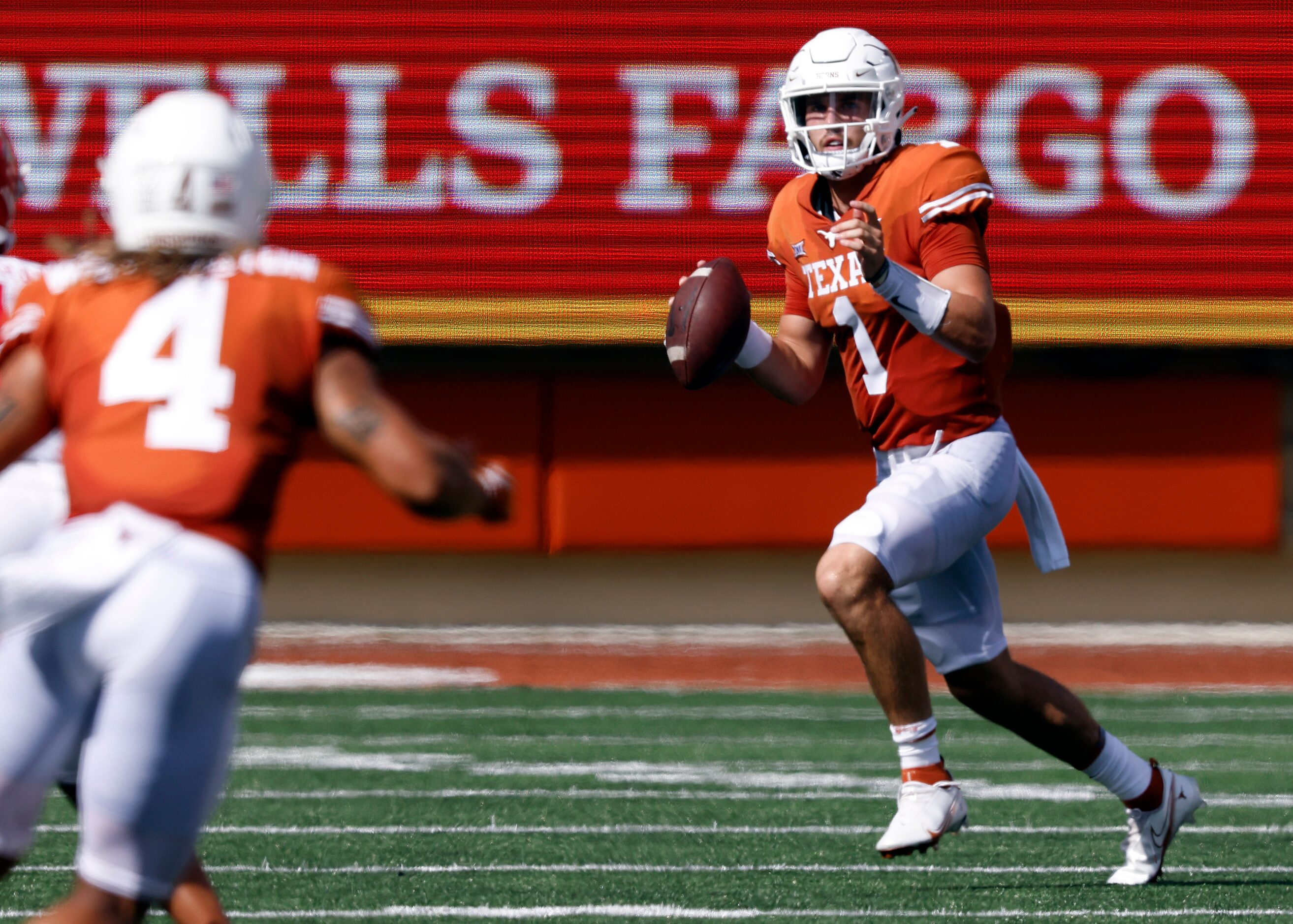 Texas Longhorns quarterback Hudson Card (1) rolls out looking for wide receiver Jordan...