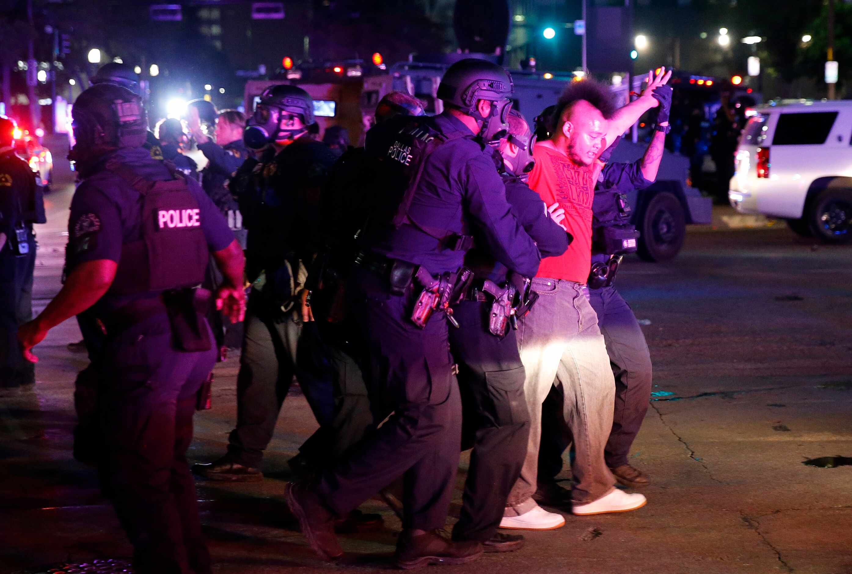 A protestor is taken into custody by Dallas Police tactical officers at Young St. and S....