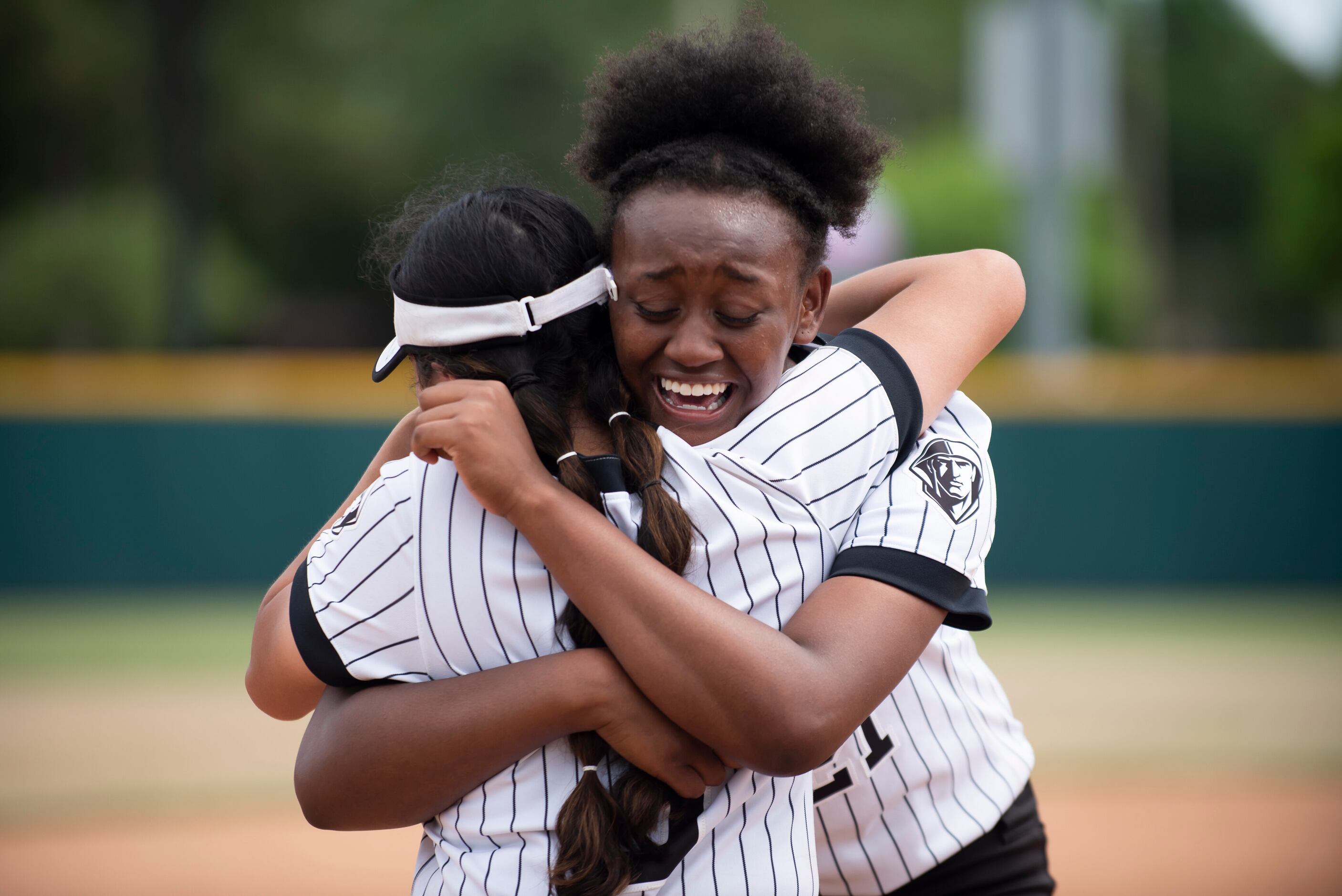 Bishop Lynch senior Alexa Gaytan (3) and junior Mya Dunn (21) embrace after winning the...