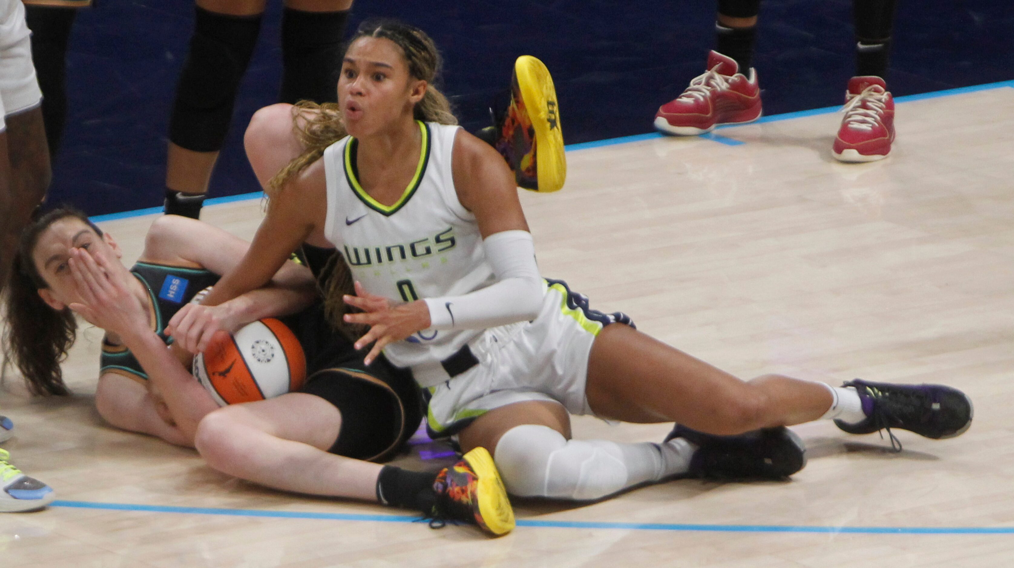 Dallas Wings forward Satou Sabally (0) reacts to a game official's call after battling with...