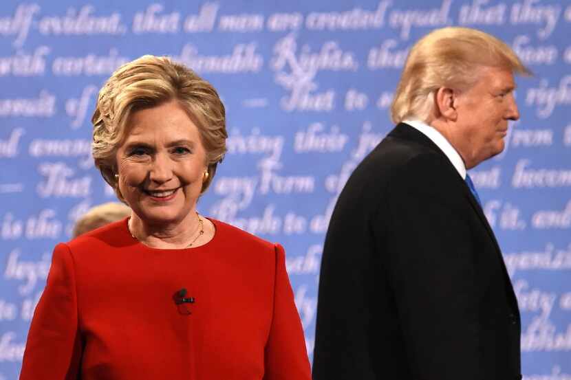 Democratic nominee Hillary Clinton (L) and Republican nominee Donald Trump leave the stage...