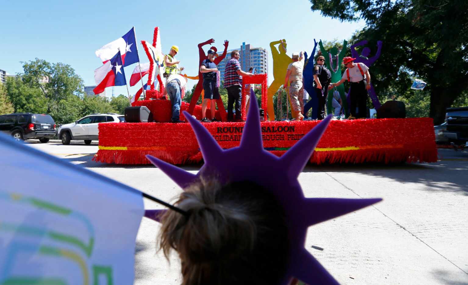 Alyssa Crawford, 15, watched the Roundup Saloon float on Sunday along Turtle Creek Boulevard. 