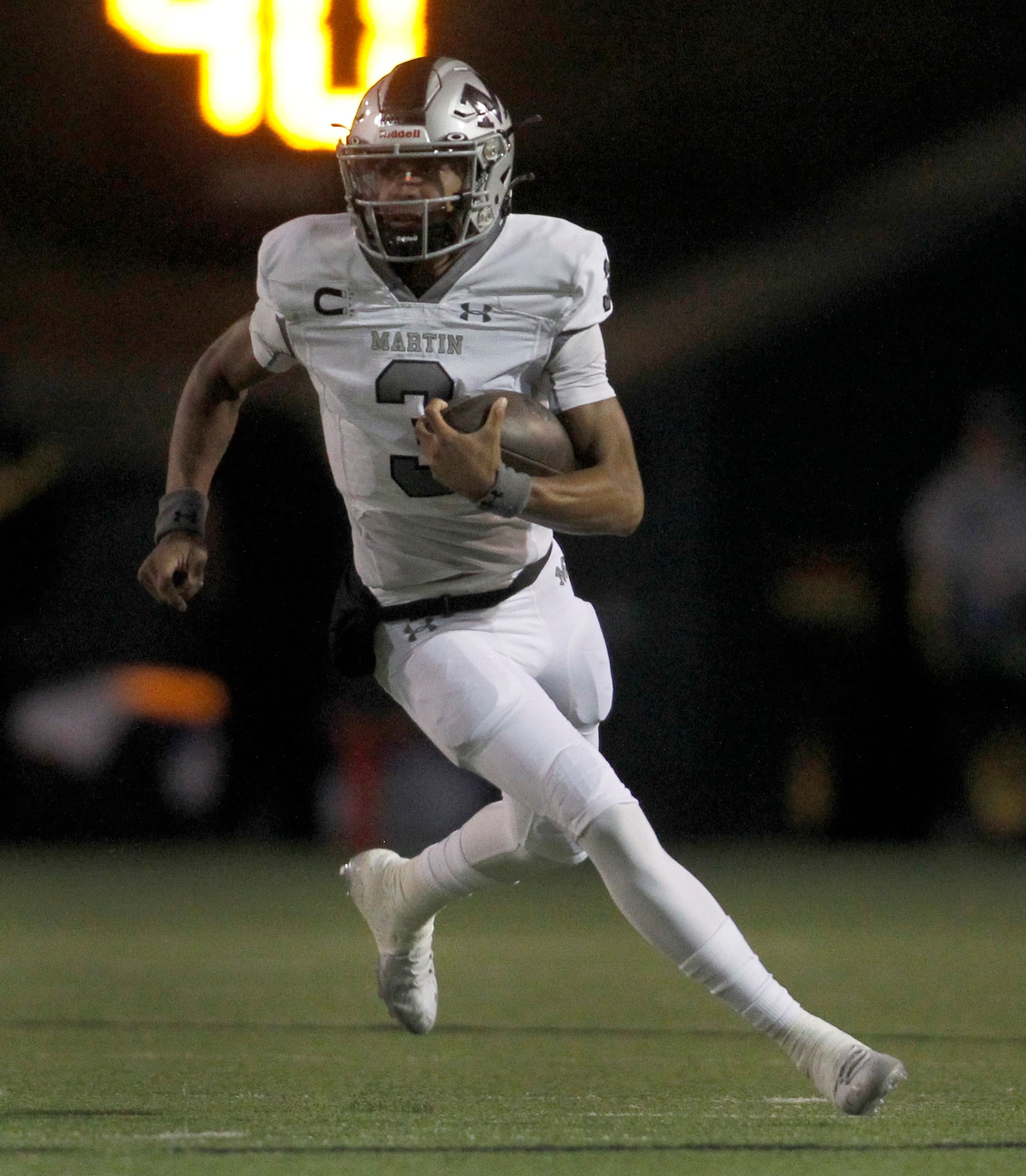 Arlington Martin quarterback Cydd Ford (3) rushes for a first down during first quarter...