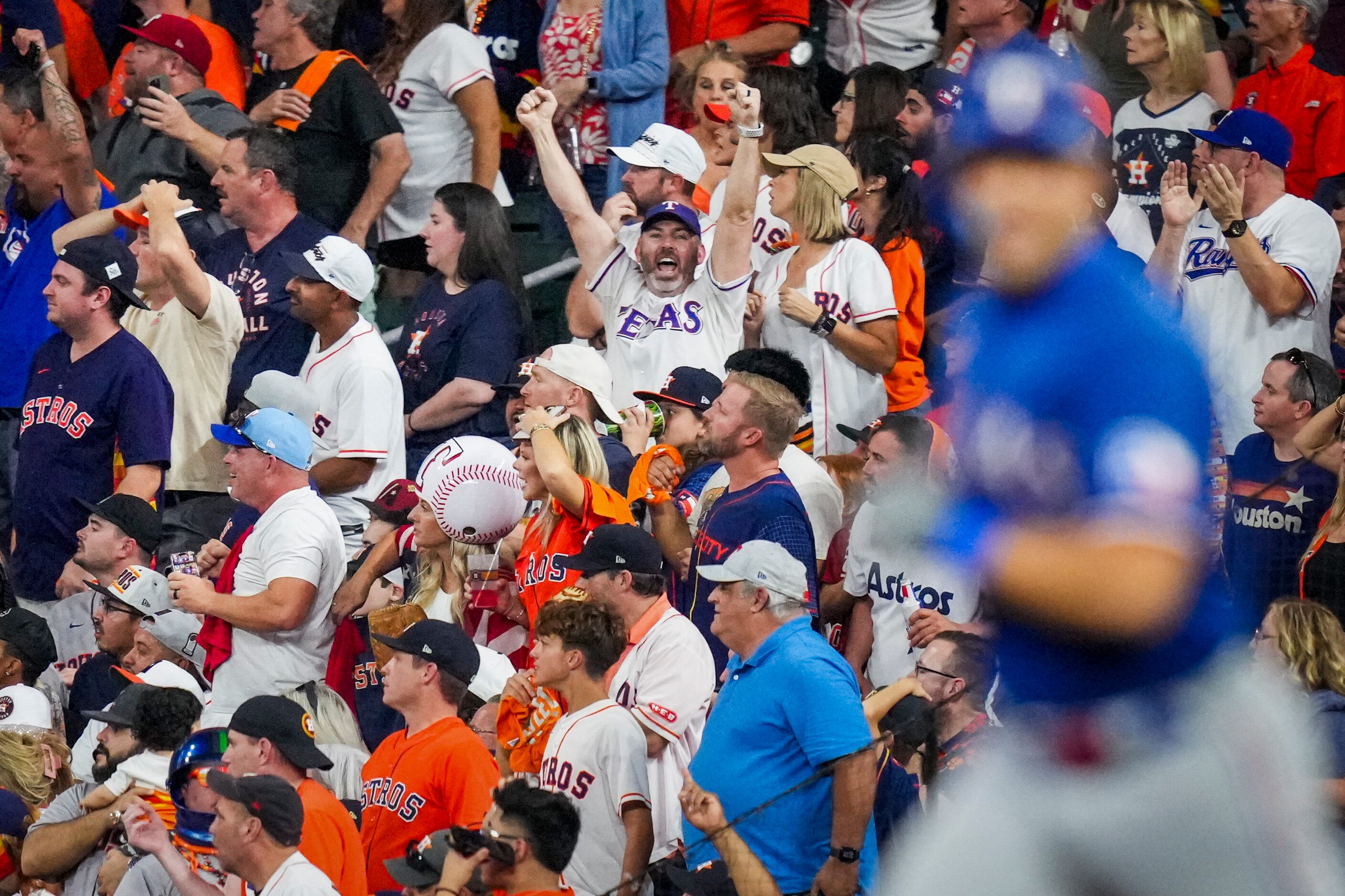 A Texas Rangers fan cheers as Texas Rangers first baseman Nathaniel Lowe rounds the bases...