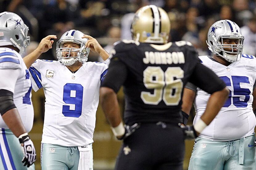 Dallas Cowboys quarterback Tony Romo (9) calls a hurry-up play against the New Orleans...