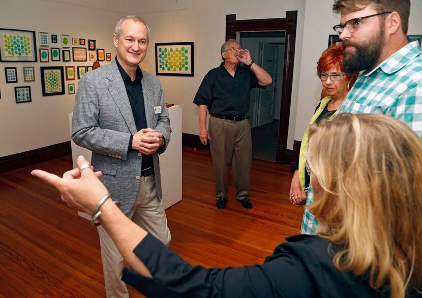
Coleman meets with artists whose work is being exhibited at a reception at 901 18th St. It...