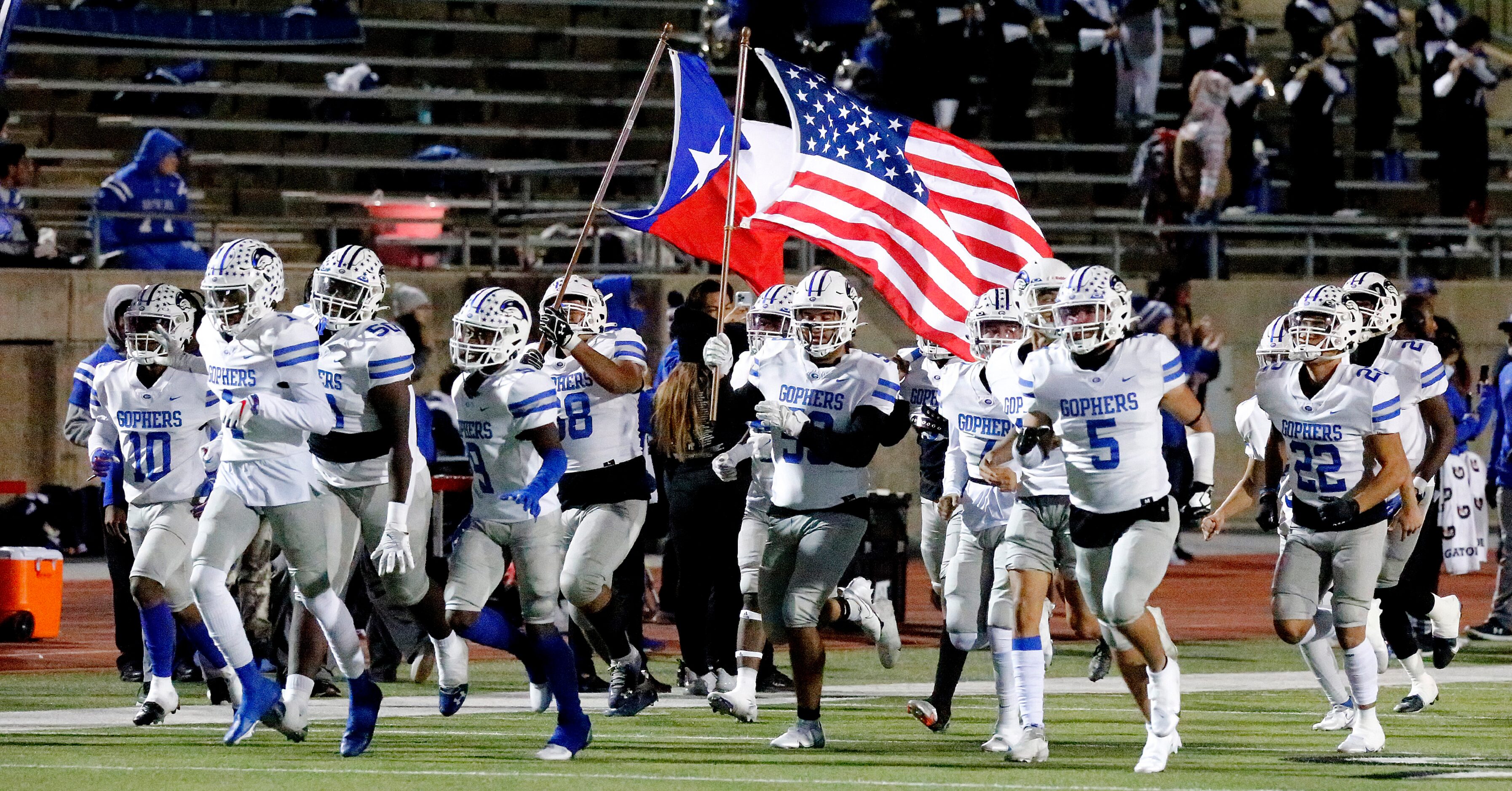 The Grand Prairie High School football team takes the field before kickoff as Grand Prairie...