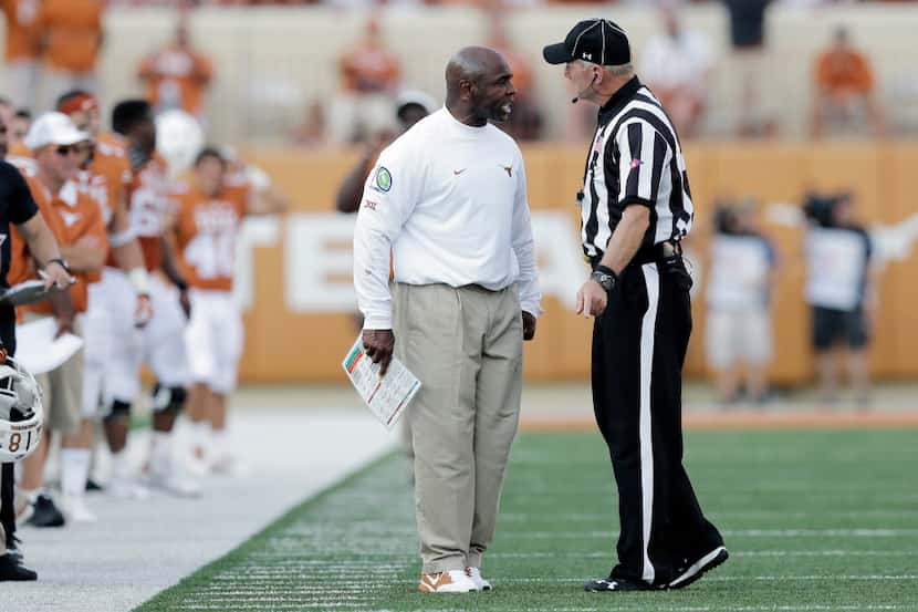 Texas head coach Charlie Strong, left, argues with an official during the second half of an...