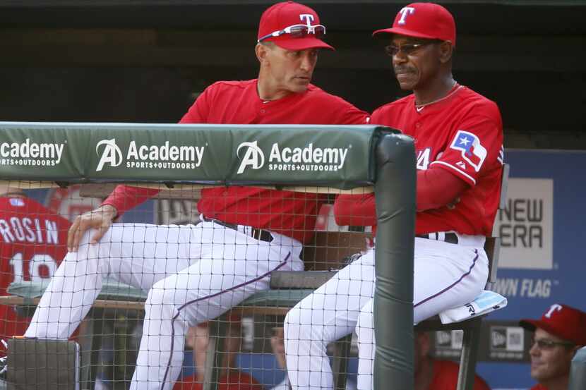 Texas manager Ron Washington, right, and bench coach Tim Bogar talk as they watch the bottom...