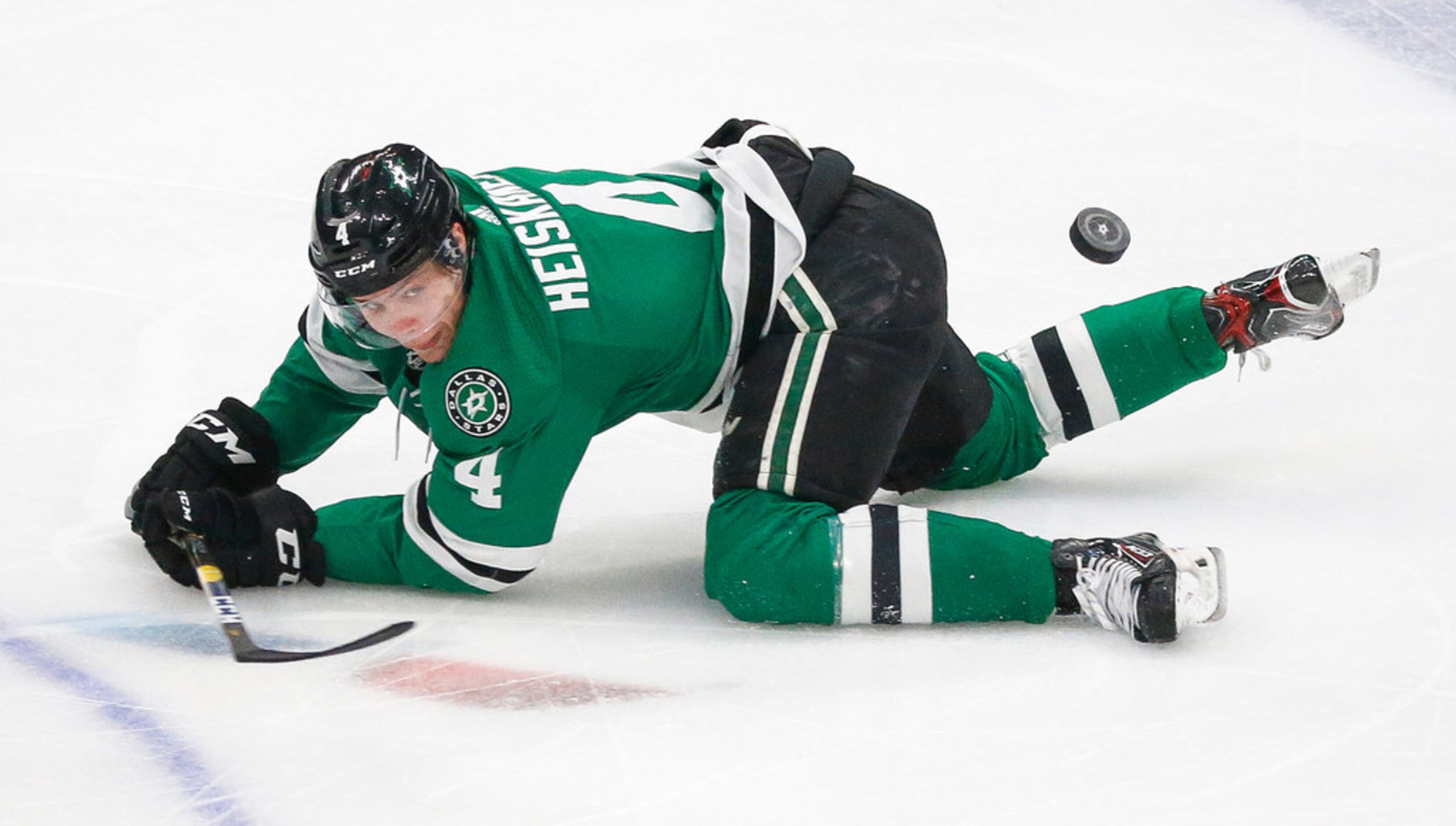 Dallas Stars defenseman Miro Heiskanen (4) falls to the ice during the second period of a...