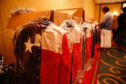 Gayle Sayers of Converse sorted Texas flag shirts donated by Houston insurance agent Norman...