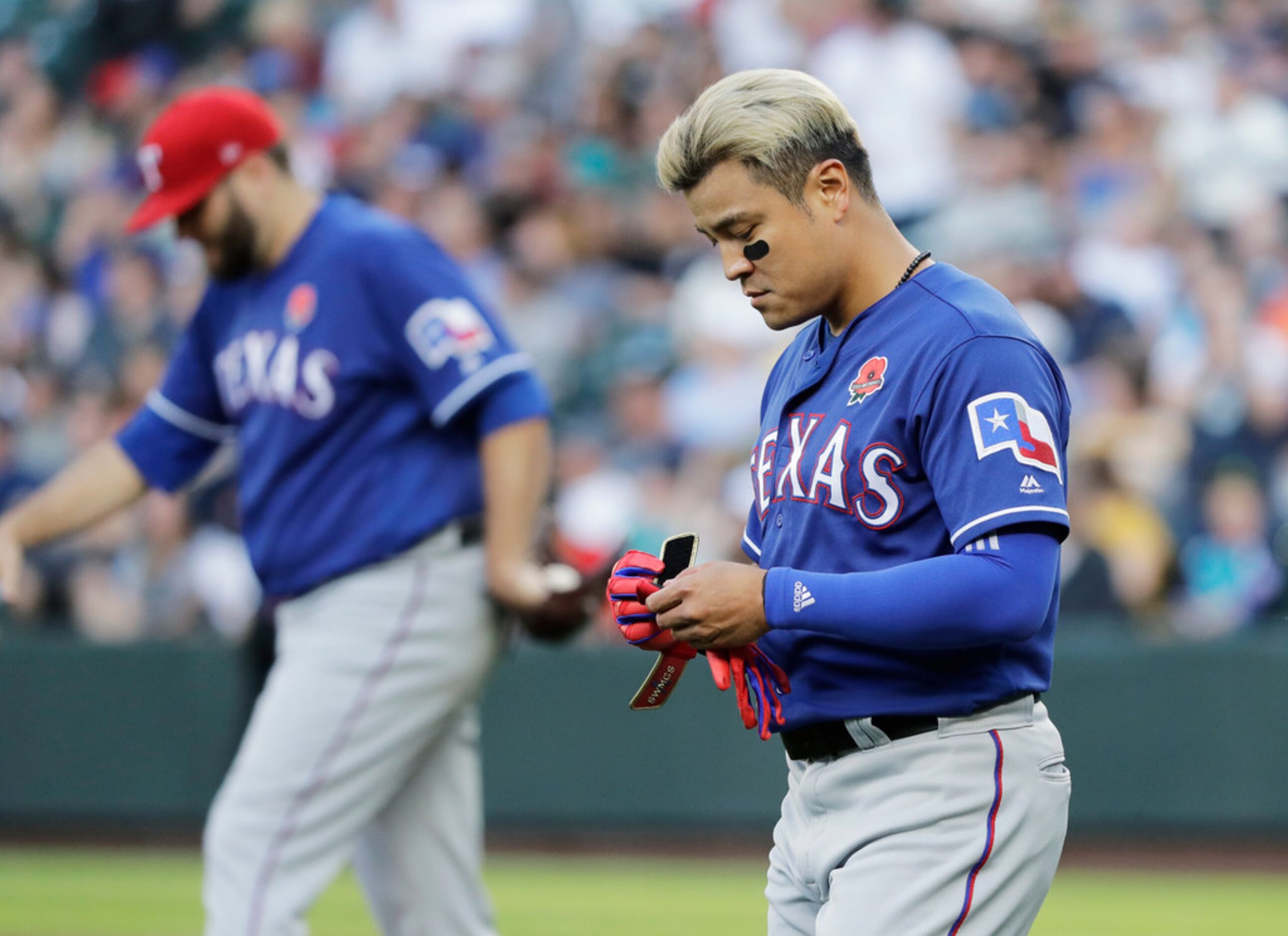 Texas Rangers' Shin-Soo Choo, right, walks to left field as starting pitcher Lance Lynn,...