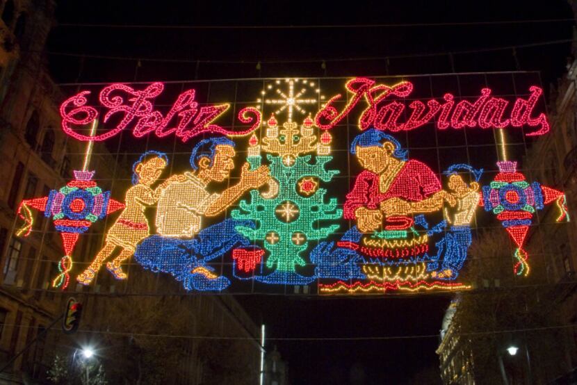 Huge murals of Christmas lights decorate the buildings around Mexico City's Zócalo Plaza,...