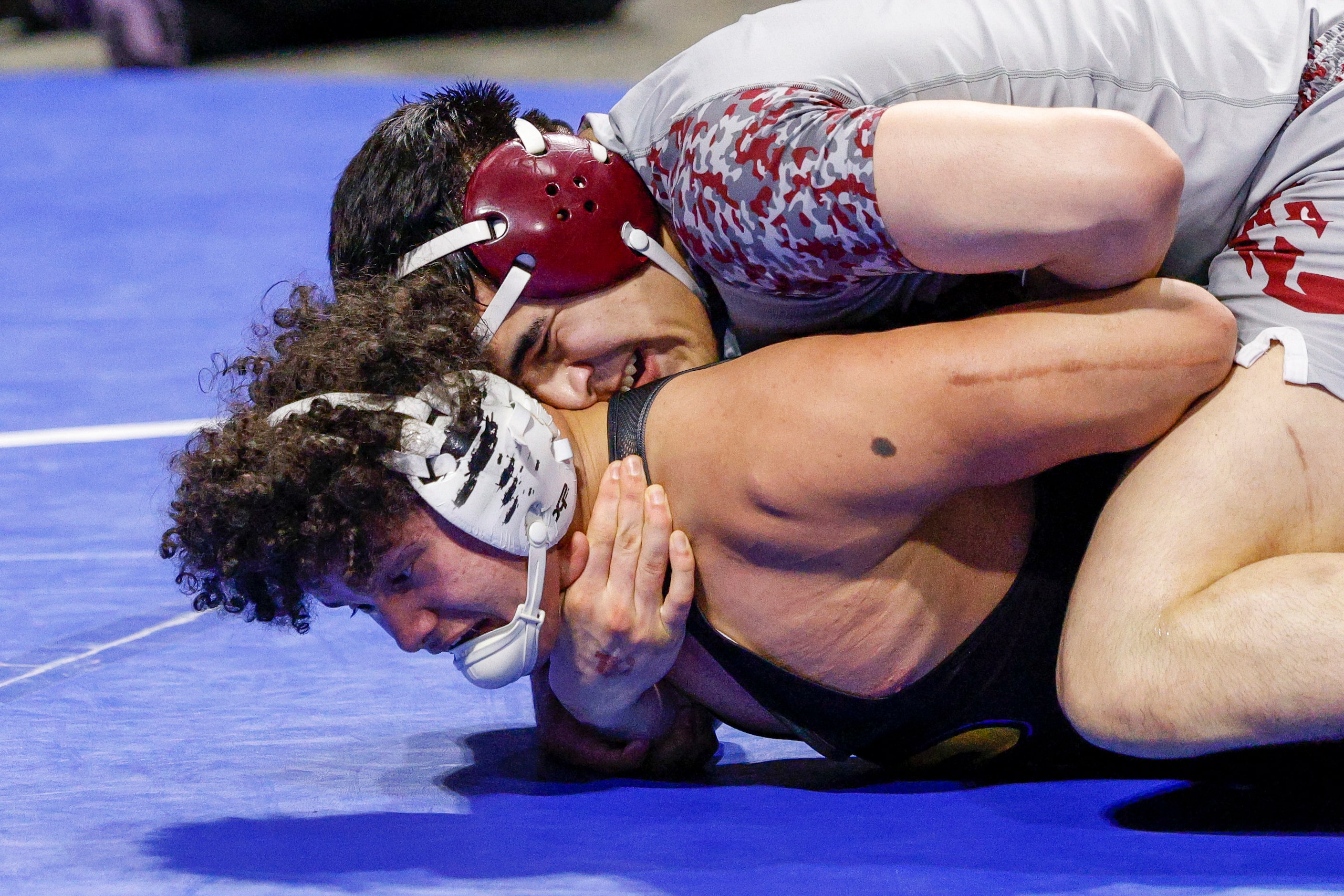 Alex Zavala of Frisco Heritage (top) wrestles Jacob Hansen of Pflugerville during the...