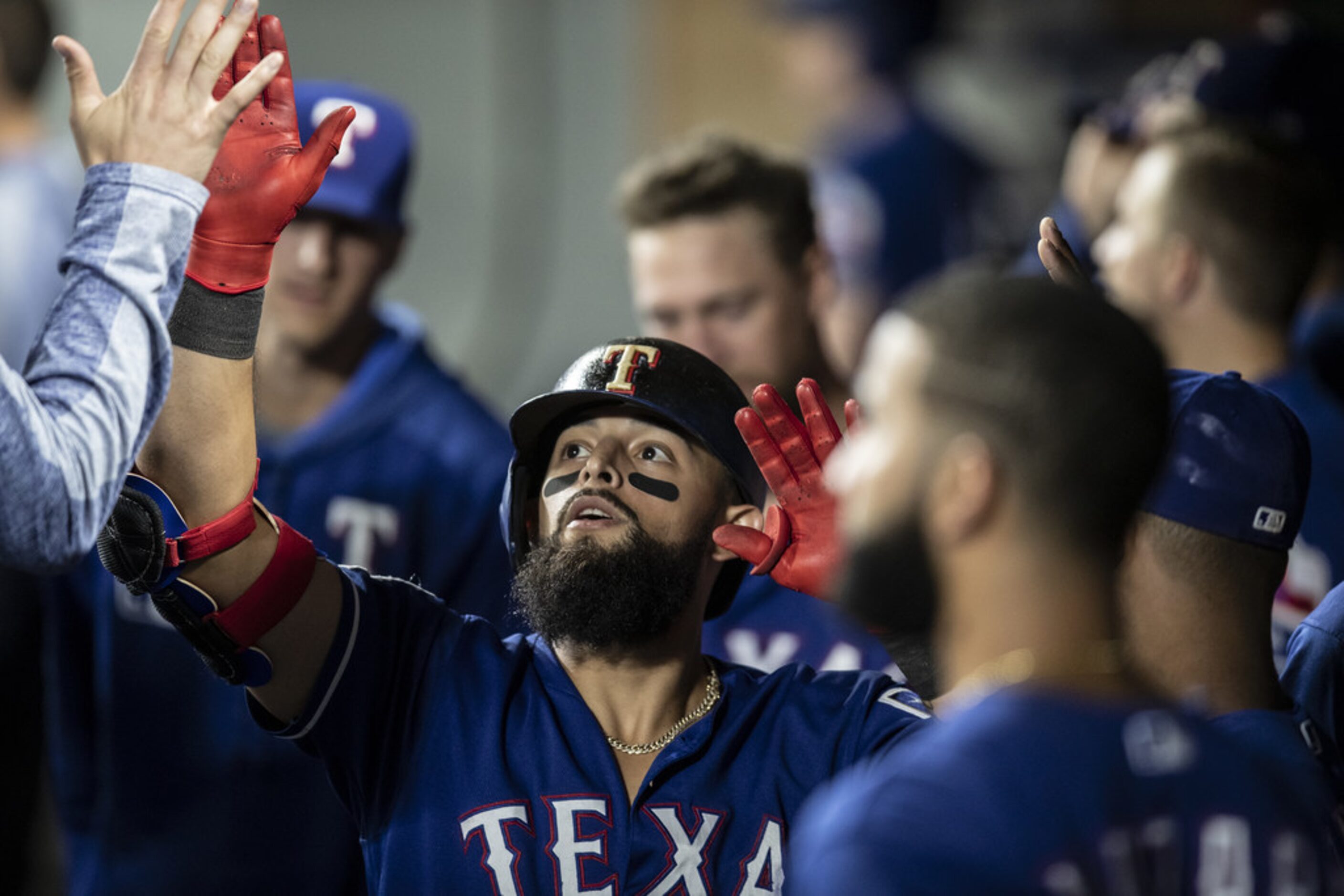 SEATTLE, WA - JULY 23: Rougned Odor #12 of the Texas Rangers is congratulated by teammates...