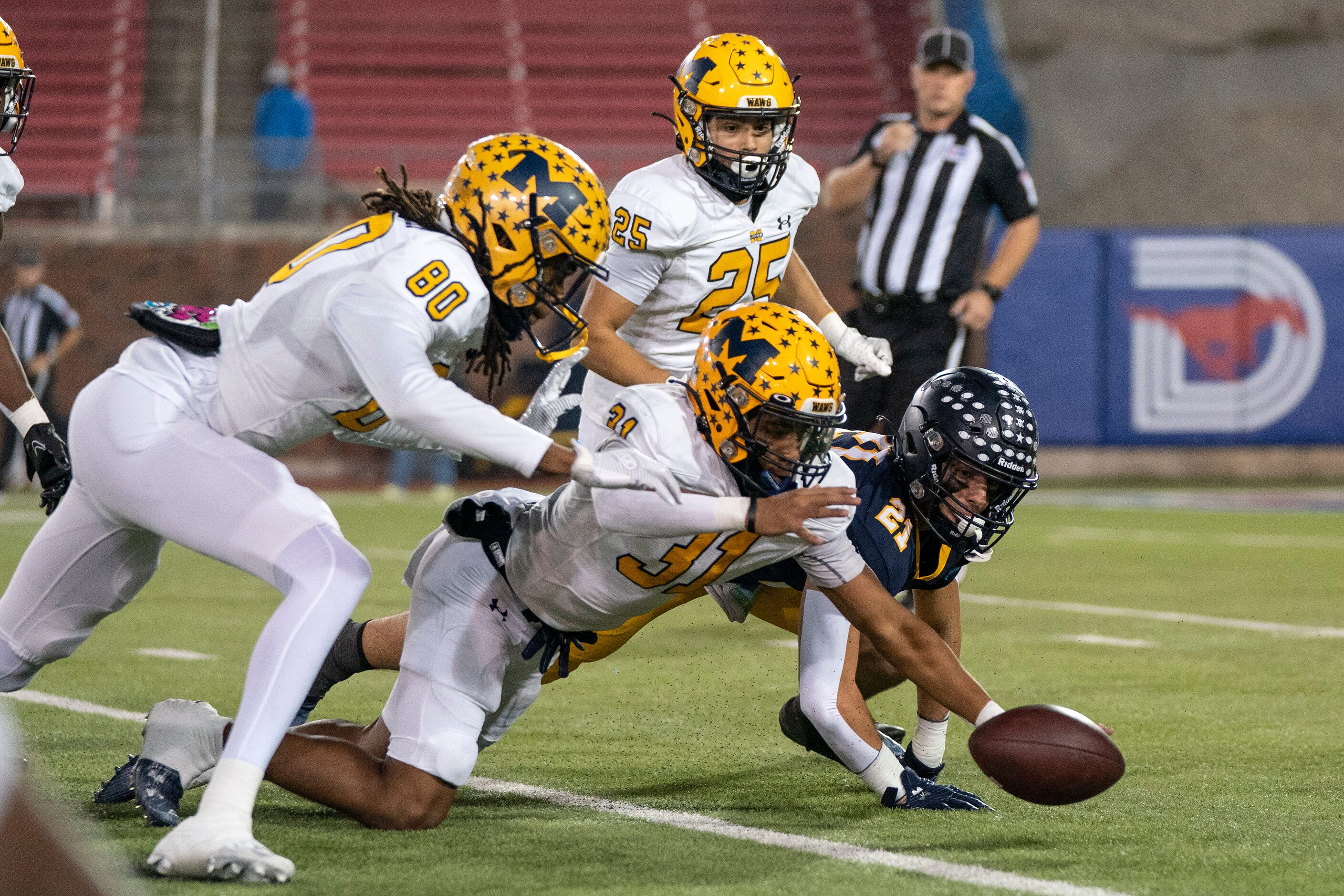 McKinney defenders Jeremiah Sowe (31), Ja’Bre Bickam (80) and Bradon Roberts (25) try to...