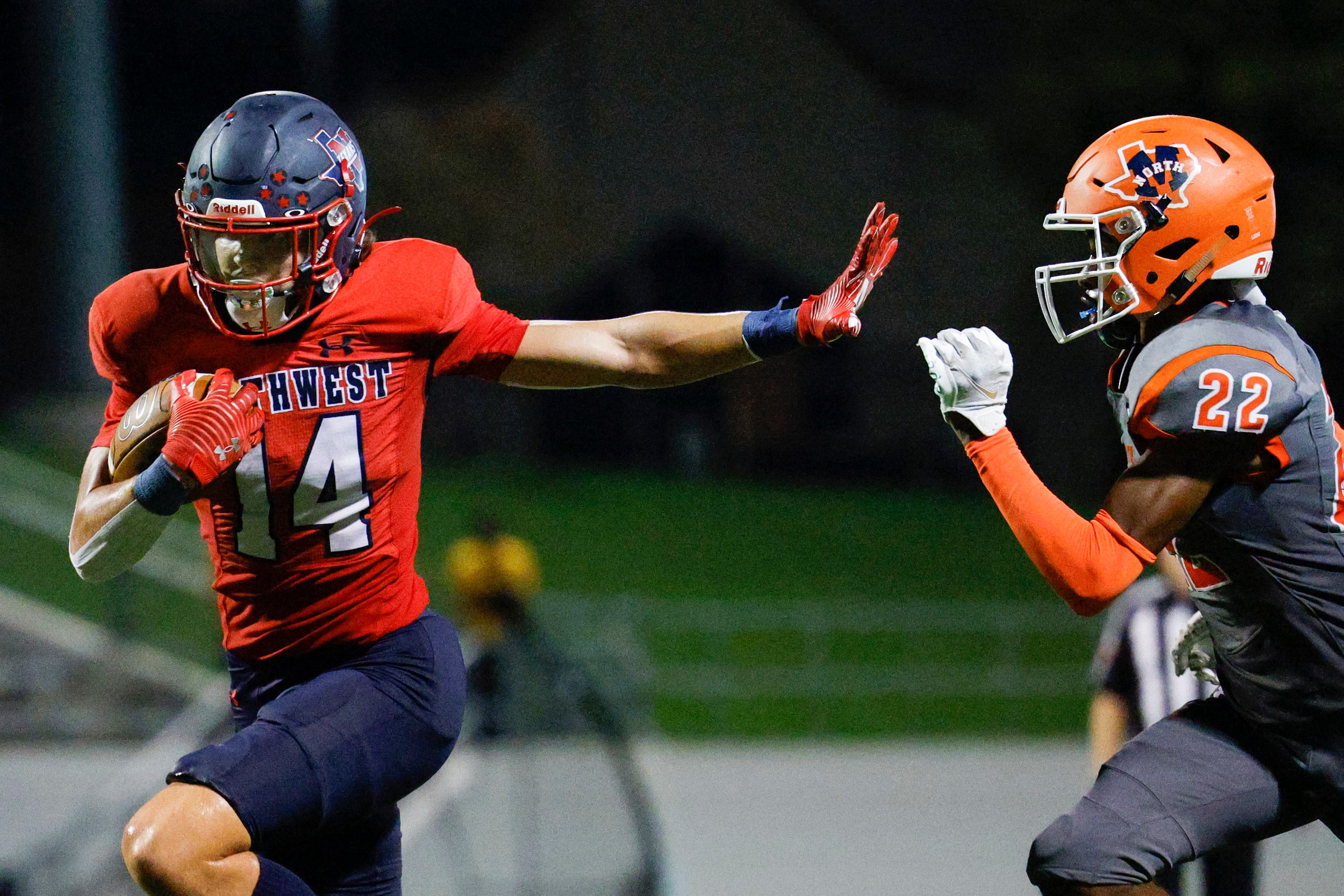 Justin Northwest wide receiver Logan Jeskevic (14) stiff arms McKinney North cornerback...