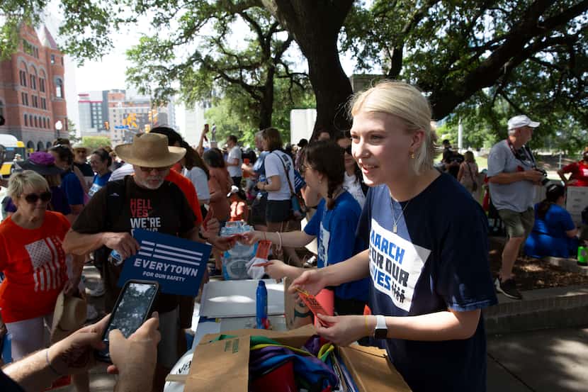 Karter Stanton (right), a Dallas March for Our Lives organizer, checks in protesters at the...
