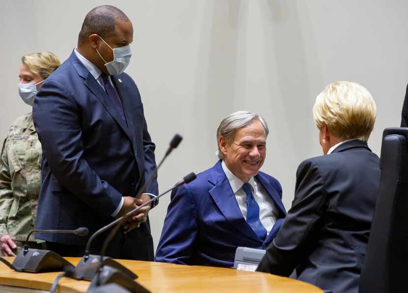 Dallas Mayor Eric Johnson, with Gov. Greg Abbott and and then-Fort Worth Mayor Betsy Price...