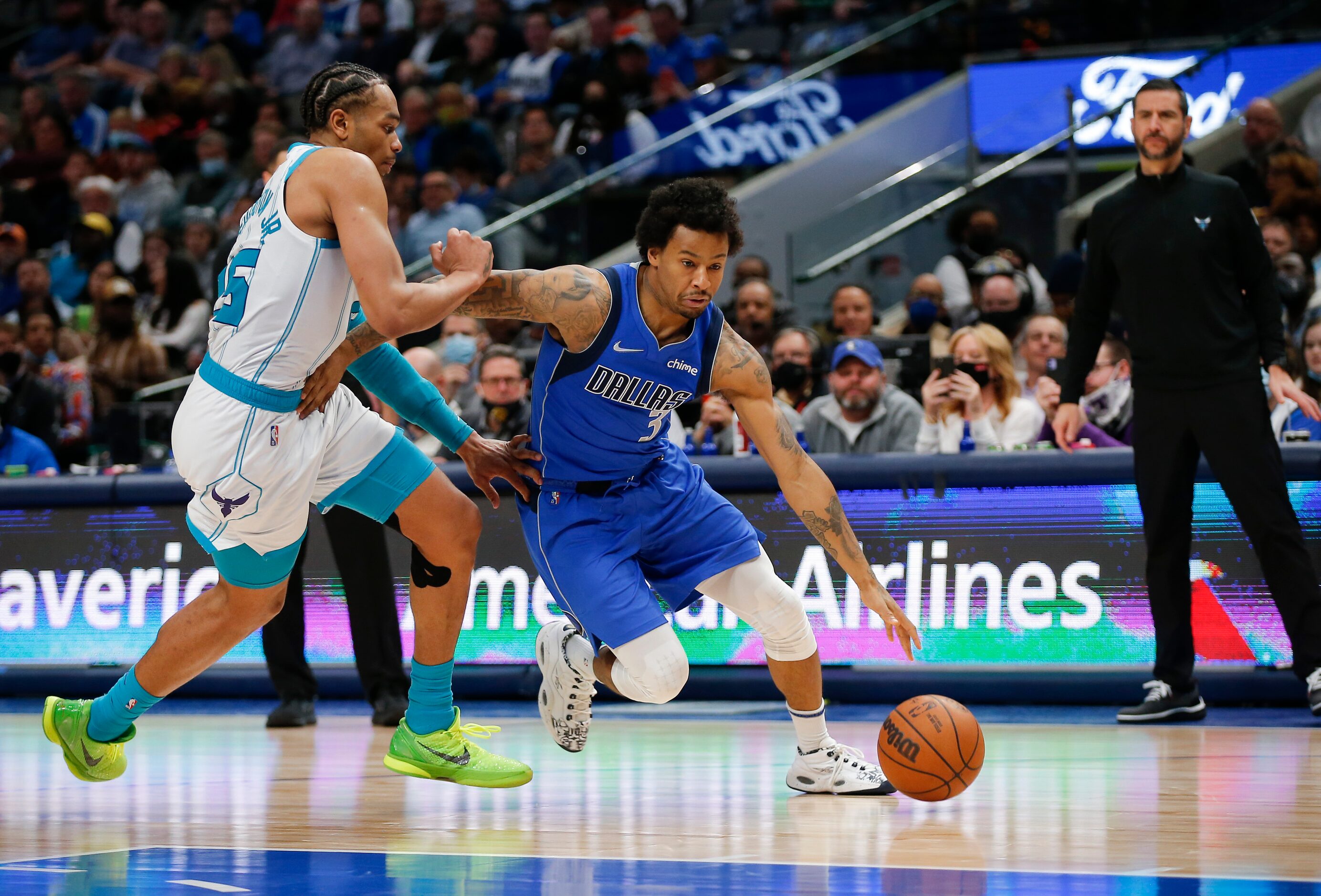 Dallas Mavericks guard Trey Burke (3) battles Charlotte Hornets forward P.J. Washington (25)...