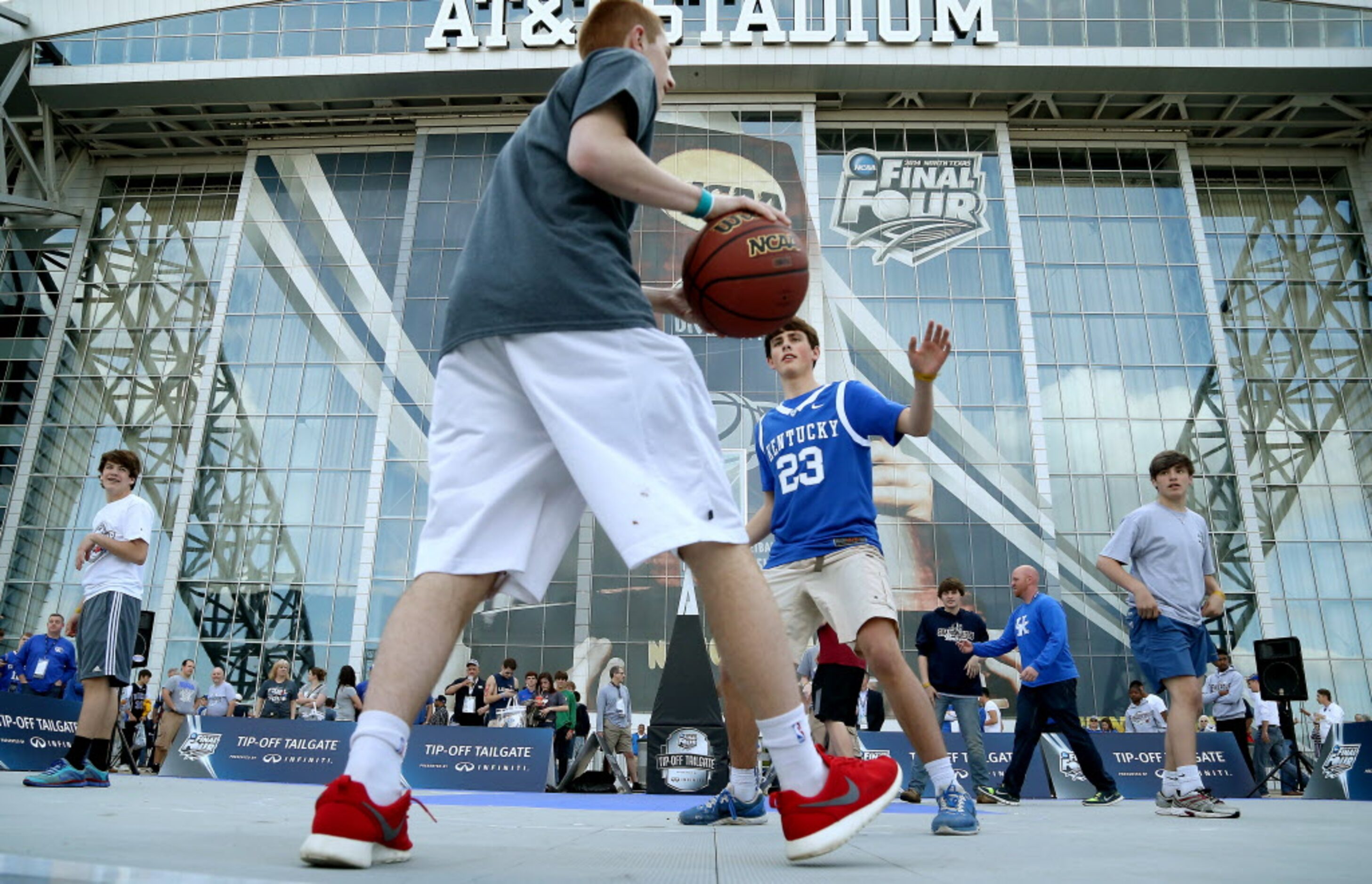 Fans play half-court basketball on the main court in the Tip-Off Tailgate presented by...