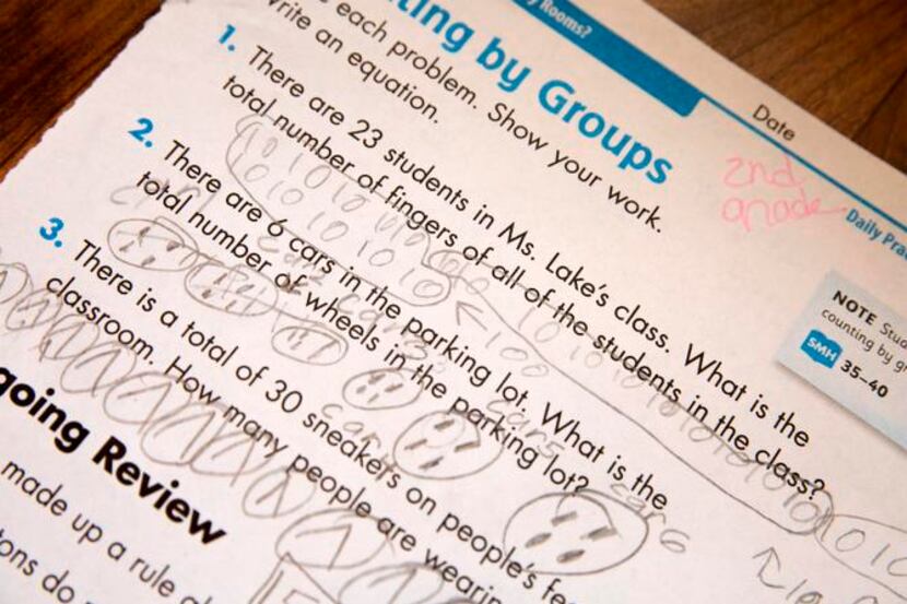 A second-grade worksheet shows the work done by a student using the Common Core method....