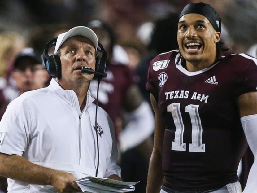 Texas A&M Aggies head coach Jimbo Fisher and quarterback Kellen Mond (11) watch as a play is...